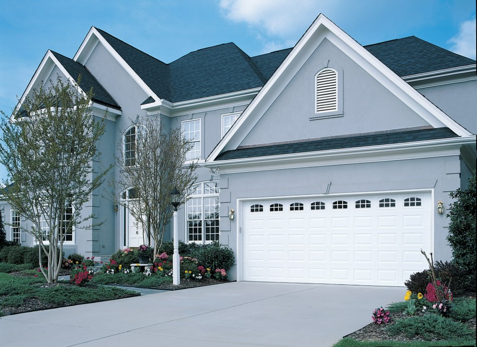 Exterior view of a home with an insulated garage door