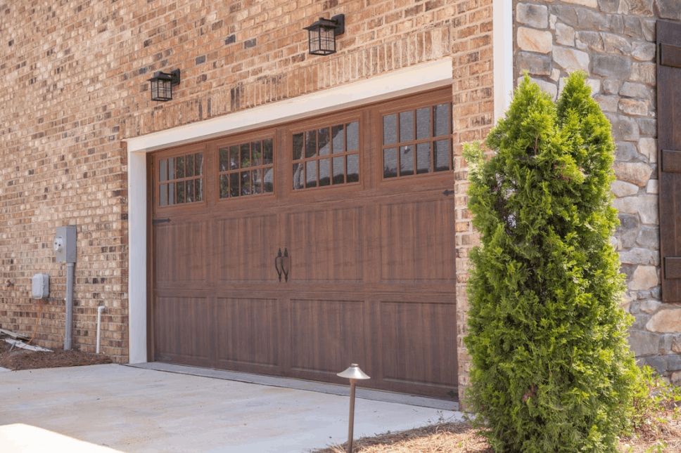 A dark brown wood-look garage door on a home.